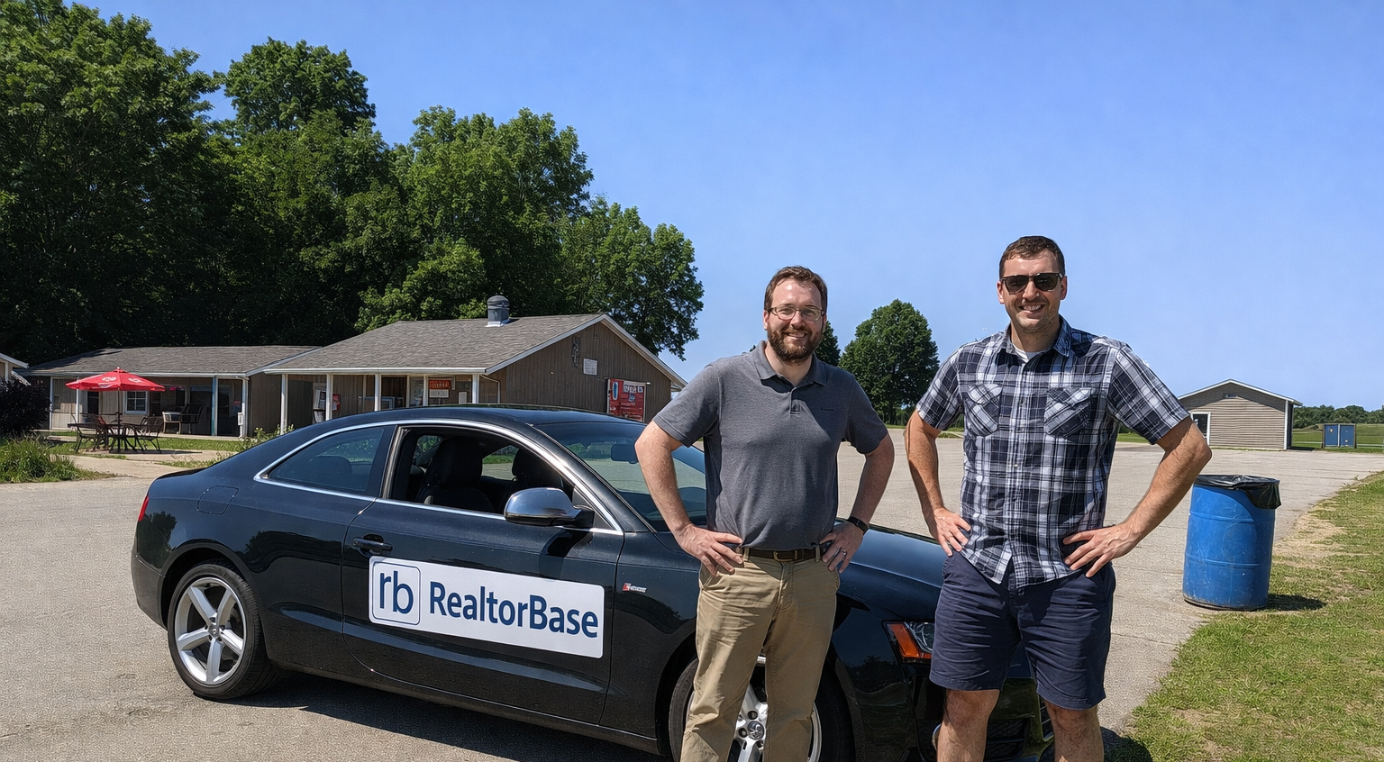 Two goofball Engineers standing in front of Black car